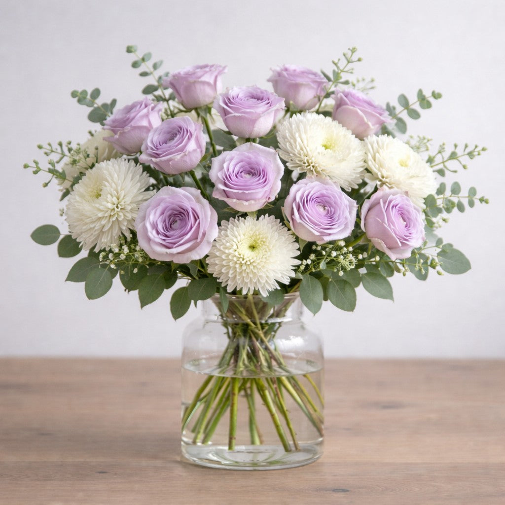 Lavender Grace purple and white garden-style vase bouquet with lavender roses, white chrysanthemums, baby’s breath, and fresh eucalyptus greenery - Same-day flowers Carlsbad.