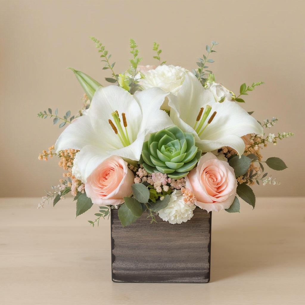 Extra full size elegant floral arrangement featuring white lilies, peach roses, succulents, and lush greenery in a rustic wooden box — Local florist in North San Diego County.
