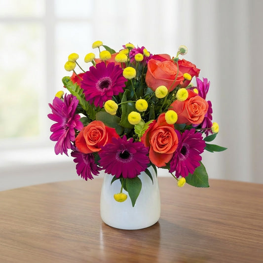 Sunset Spark regular size vase arrangement with orange roses and pink gerbera daisies, Carlsbad flower delivery.