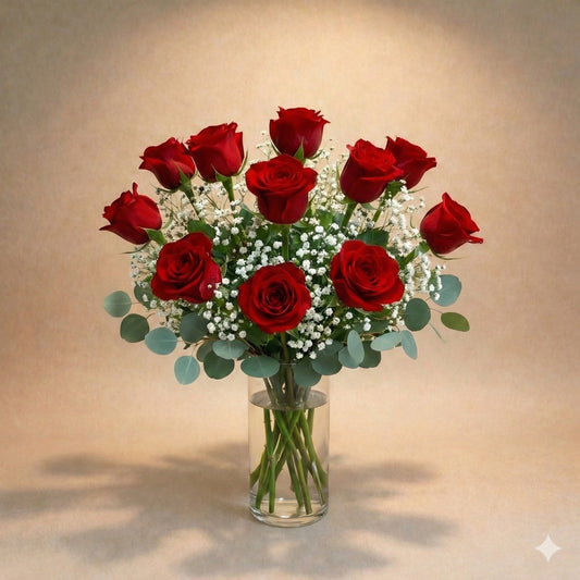 Regular size classic red rose arrangement with long-stem red roses, white baby’s breath, and greenery in a clear round glass vase — Vista flower delivery.