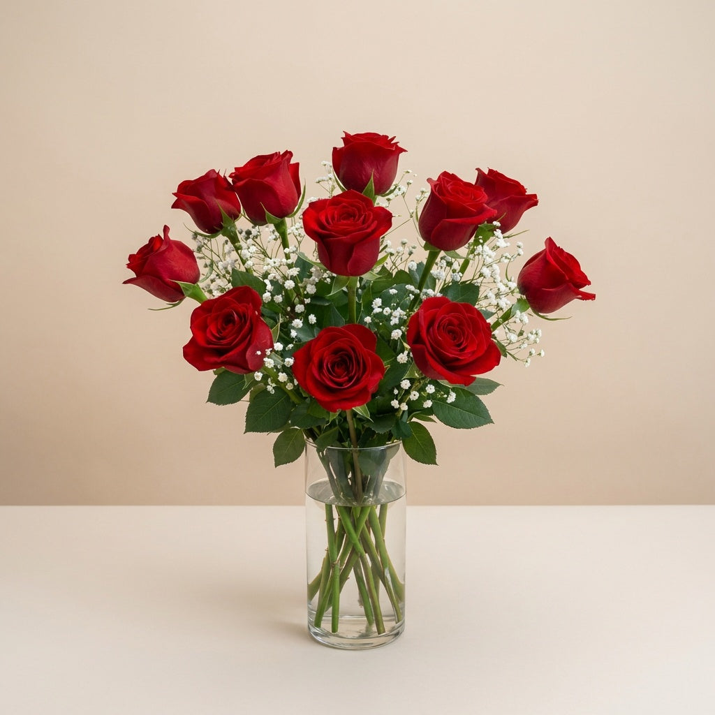 Regular size classic red rose arrangement with long-stem red roses, white baby’s breath, and greenery in a clear round glass vase — Vista flower delivery.