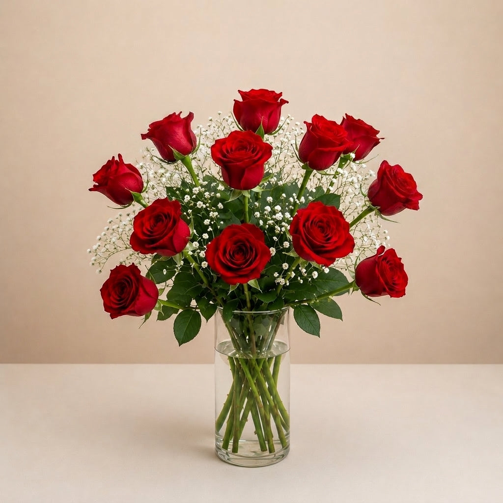 Regular size classic red rose arrangement with long-stem red roses, white baby’s breath, and greenery in a clear round glass vase — Vista flower delivery.