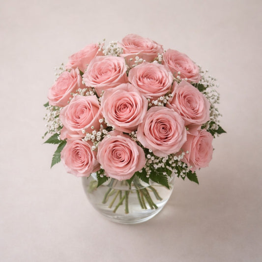Top view of elegant blush rose bouquet featuring 18 premium blush pink roses arranged in a clear vase – San Marcos flower delivery.