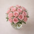 18 blush roses in clear vase with elegant pink blooms