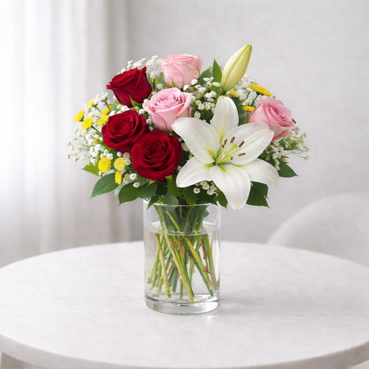 Elegant lily and rose harmony vase featuring white lilies, red roses, blush pink blooms and fresh greenery, Vista delivery.