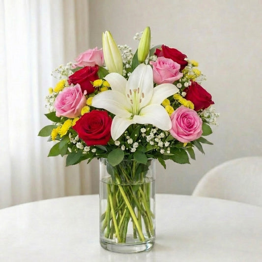 White lily and red rose arrangement in a clear glass vase with soft pink accents and yellow fillers, Vista delivery