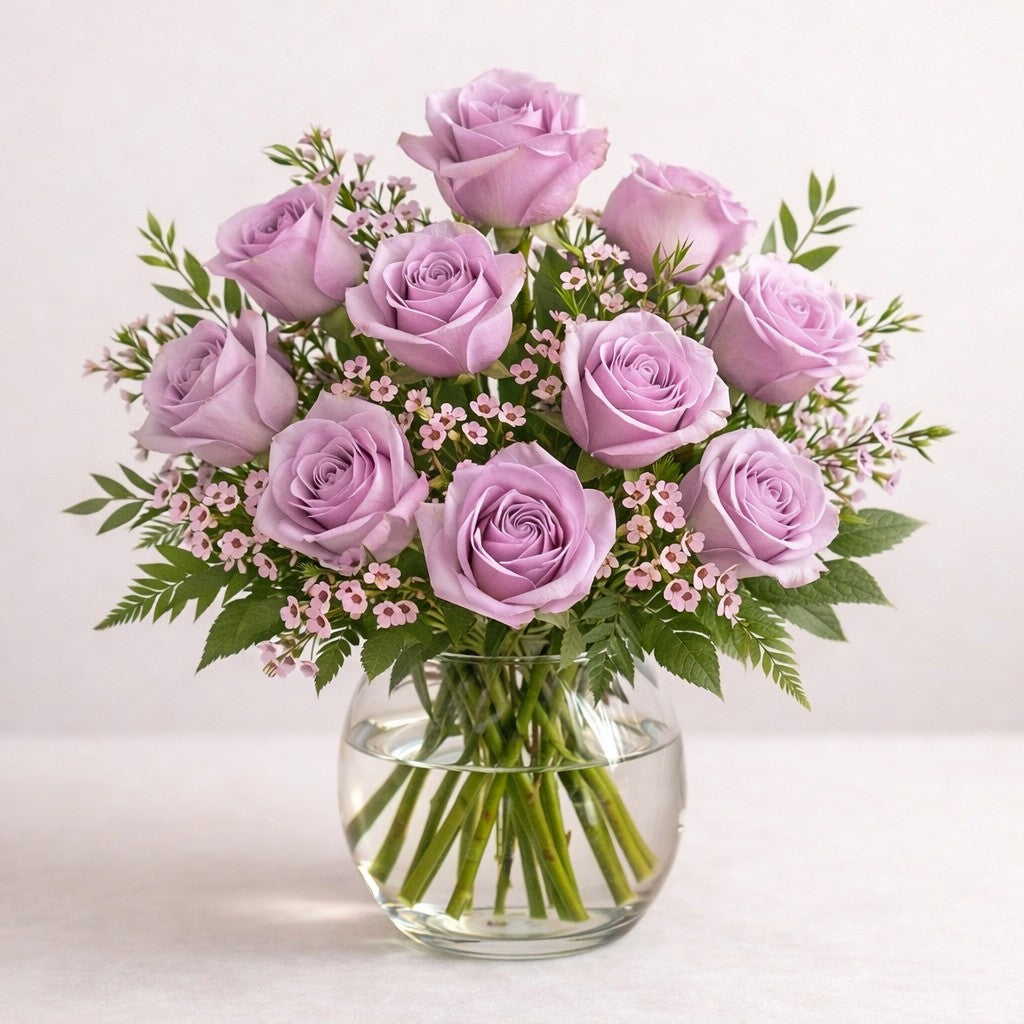 Full size lavender and blush pink rose bouquet with enhanced depth, soft greenery, and refined airy fillers in a clear glass vase, handcrafted for a graceful and calming presentation, fresh flowers Escondido CA.