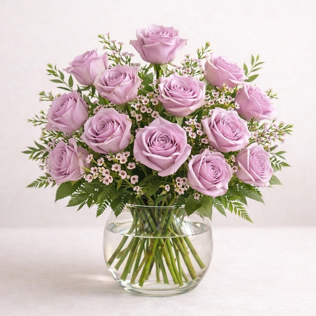 Extra full size lavender and blush pink rose arrangement featuring increased rose count, layered depth, and elegant natural movement in a clear round glass vase, fresh flowers Escondido CA.
