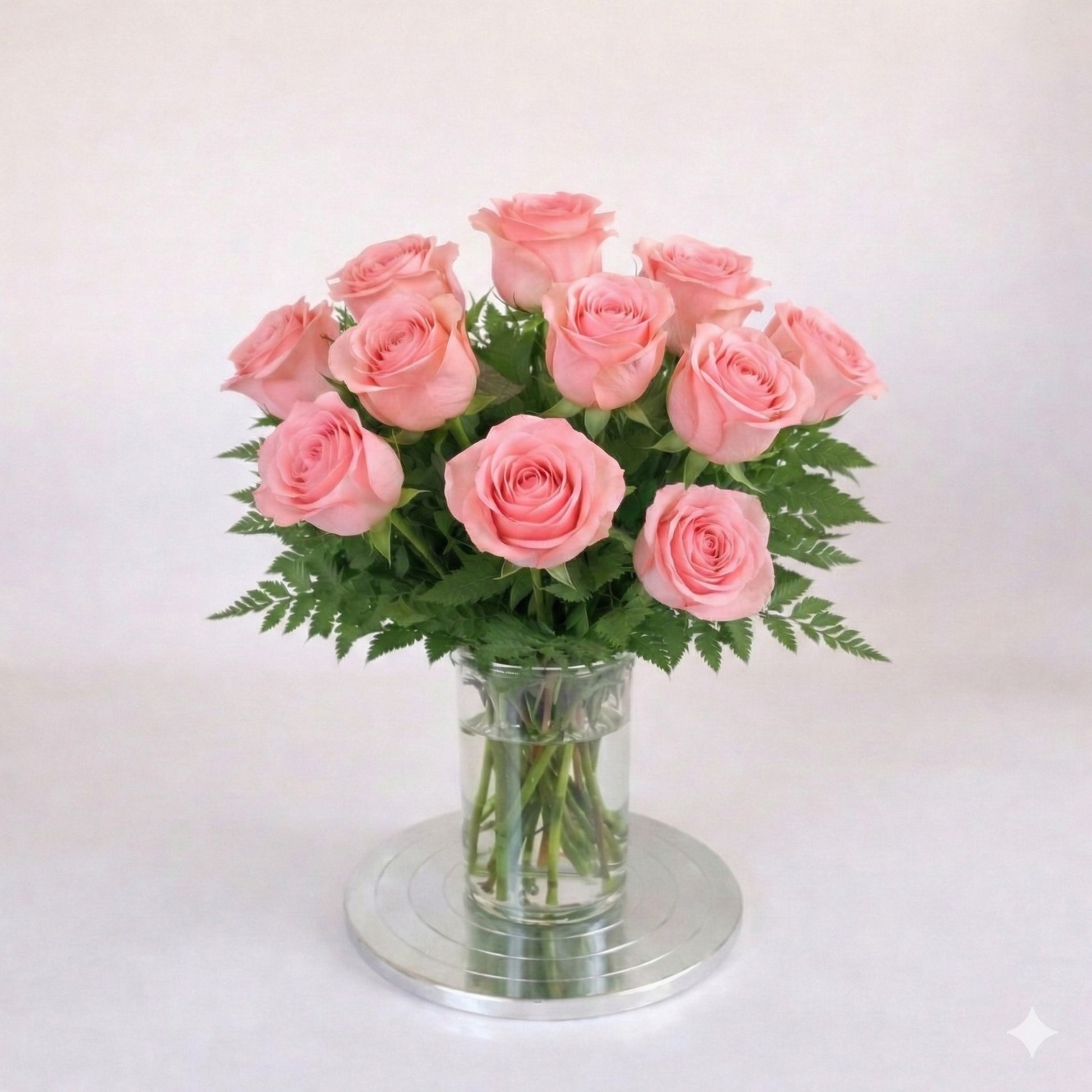 12 pink rose arrangement in a clear glass vase – San Marcos flower delivery