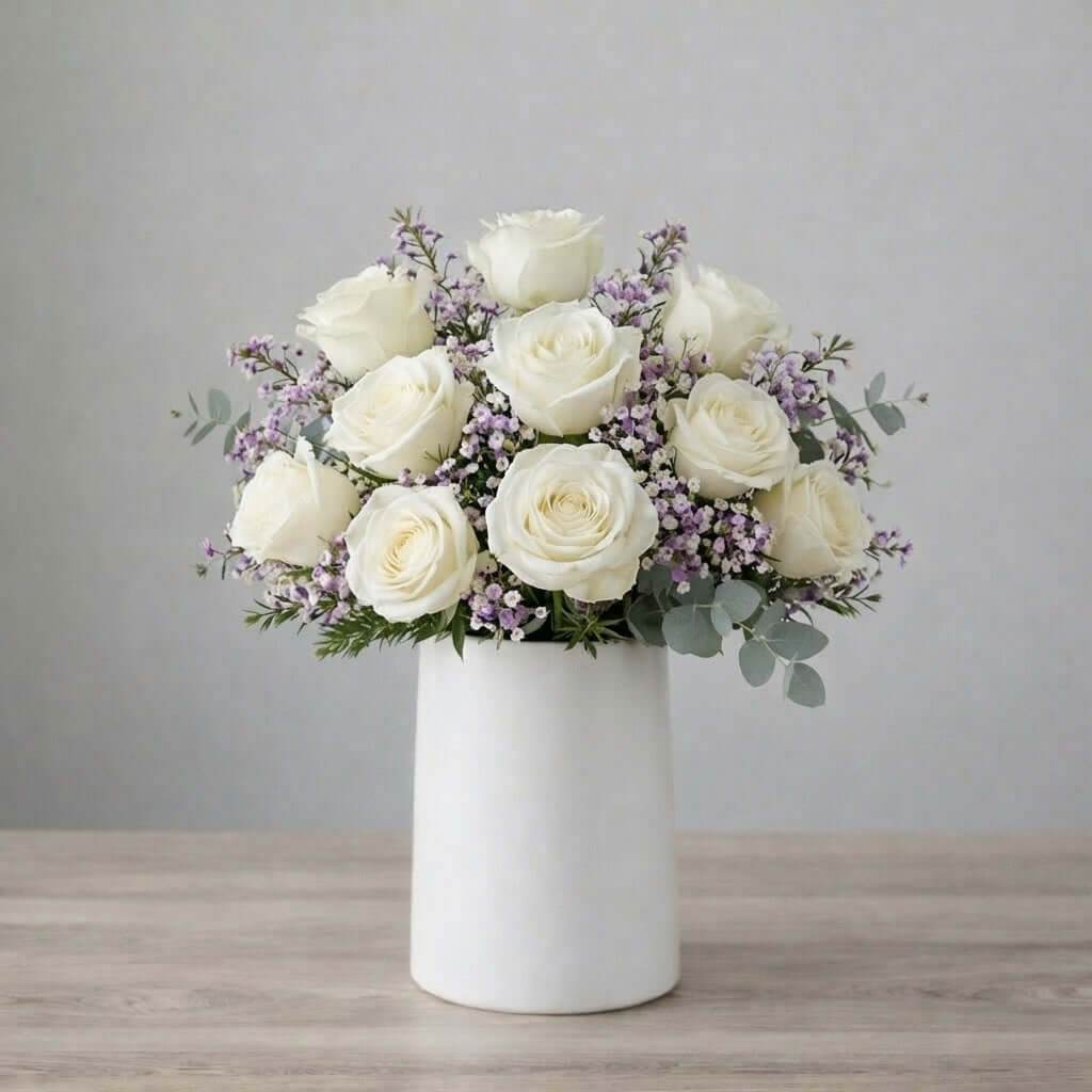 White rose and waxflower vase arrangement with elegant blooms