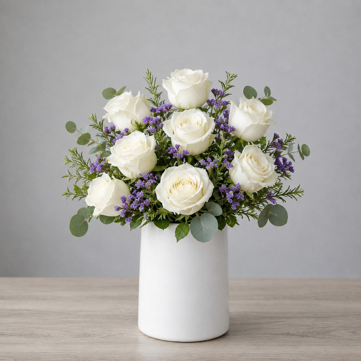 White rose and waxflower vase arrangement with elegant blooms