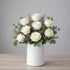 White rose and waxflower vase arrangement with elegant blooms