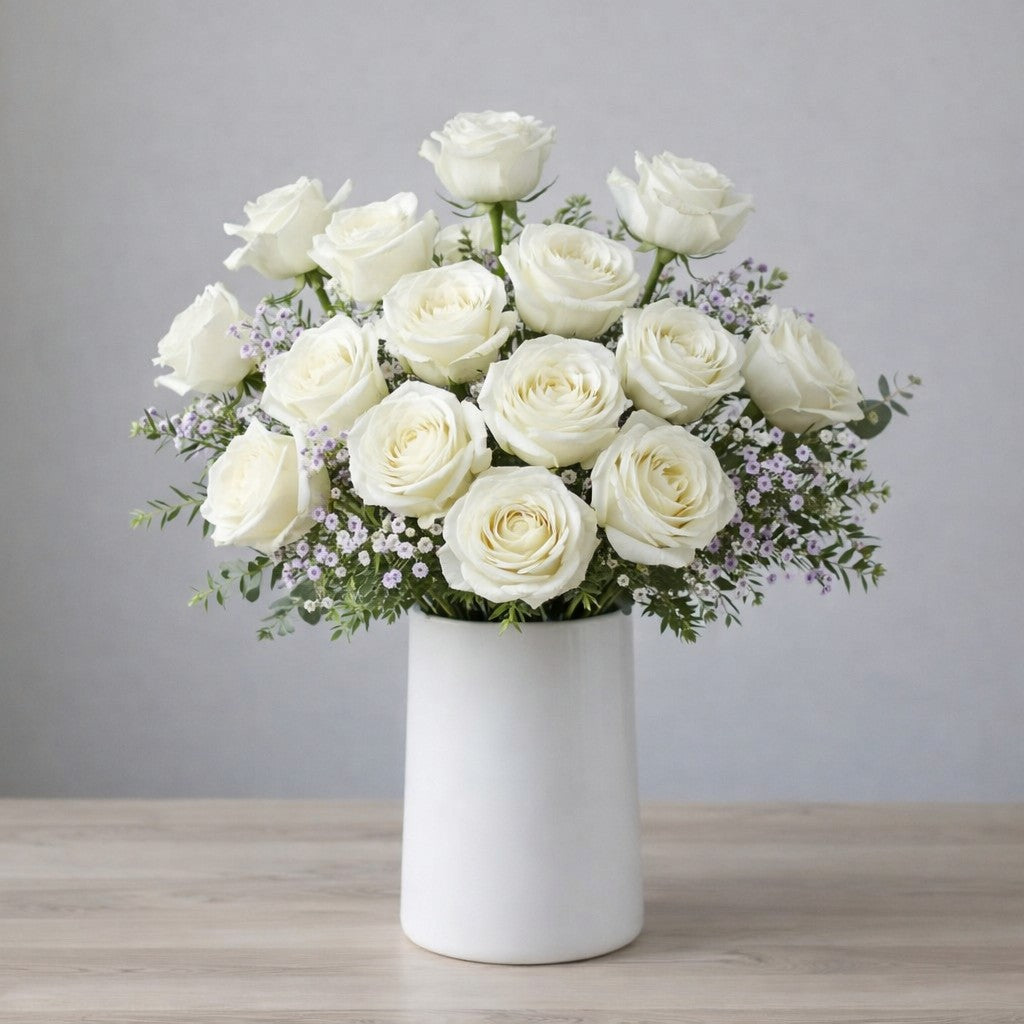 Premium white rose bouquet with lavender waxflower accents and fresh eucalyptus in a tall modern white vase — Same-day flower delivery Escondido.