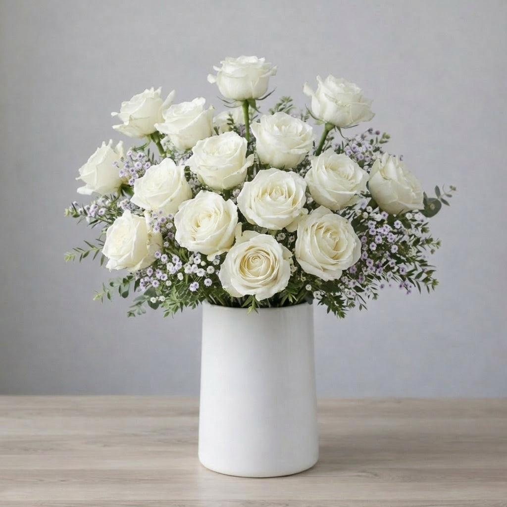 White rose and waxflower vase arrangement with elegant blooms