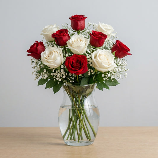 Red and white rose arrangement in a clear glass vase with soft greenery, balanced and elegant floral design, handcrafted flower delivery in Encinitas, CA