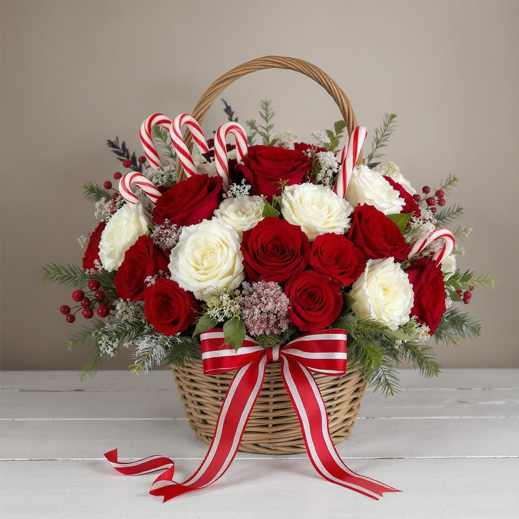 Deluxe size Christmas basket arrangement featuring extra red roses, white roses, evergreens, pinecones, candy cane accents, and a red-striped ribbon – Same-day flowers San Marcos.