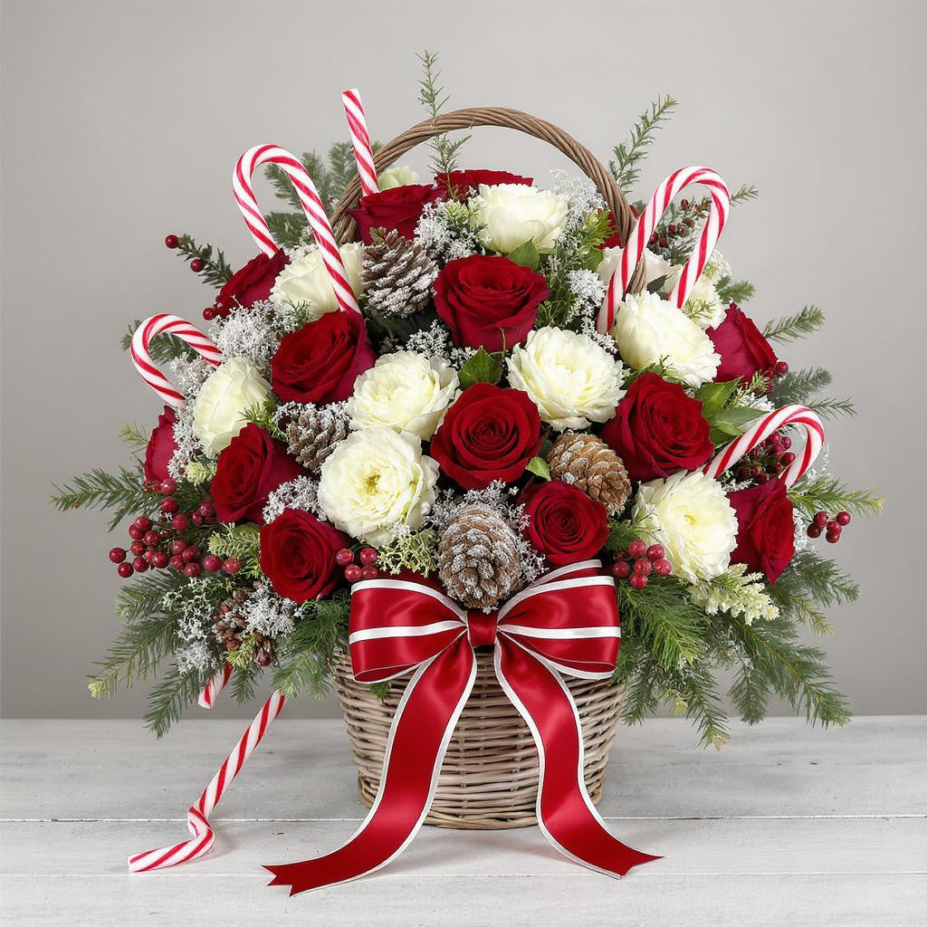 Premium size Christmas basket arrangement with abundant red roses, white roses, lush evergreens, pinecones, candy cane accents, and a full red-striped ribbon – Same-day flowers San Marcos.