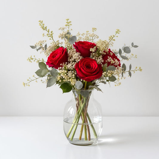 Regular size red rose and white flower arrangement with eucalyptus greenery in a clear vase — North County San Diego flower delivery.