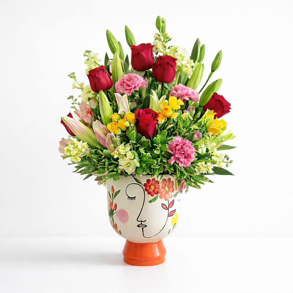 Premium red rose and lily arrangement in artistic face vase – Vista flower delivery