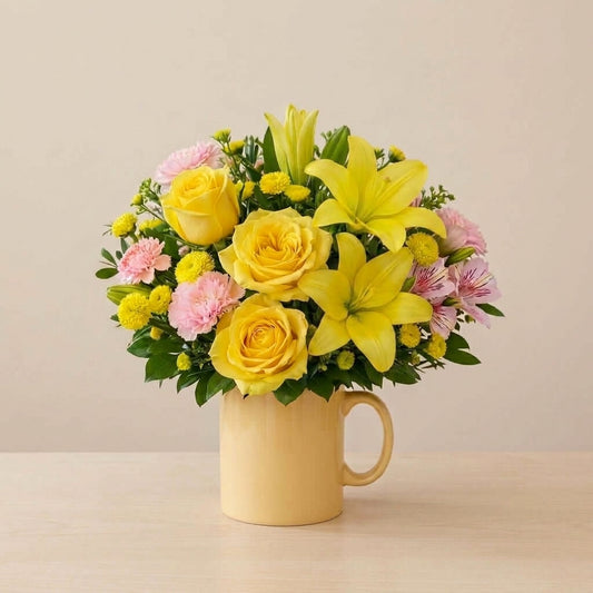 Yellow and pink flower arrangement with bright cheerful blooms