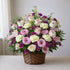 Pink and cream rose arrangement with carnations in a floral basket