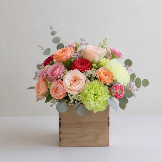 Regular size peach rose and pink carnation wooden box arrangement with green carnations and eucalyptus – Vista flower delivery