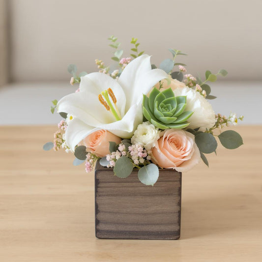 Regular size white lily, peach rose, and succulent floral arrangement with mixed greenery in a rustic wooden box — Local florist in North San Diego County.