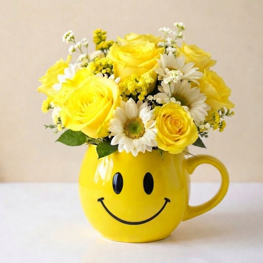 Regular size cheerful yellow bouquet with roses, daisies, and mixed flowers arranged in a yellow smiley mug — fresh flowers Oceanside CA.