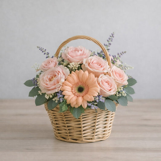 Peach gerbera and blush rose basket arrangement – Regular size flower delivery in Escondido, CA. Soft pastel floral design in a woven basket.