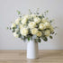 White rose bouquet in ceramic vase with elegant blooms