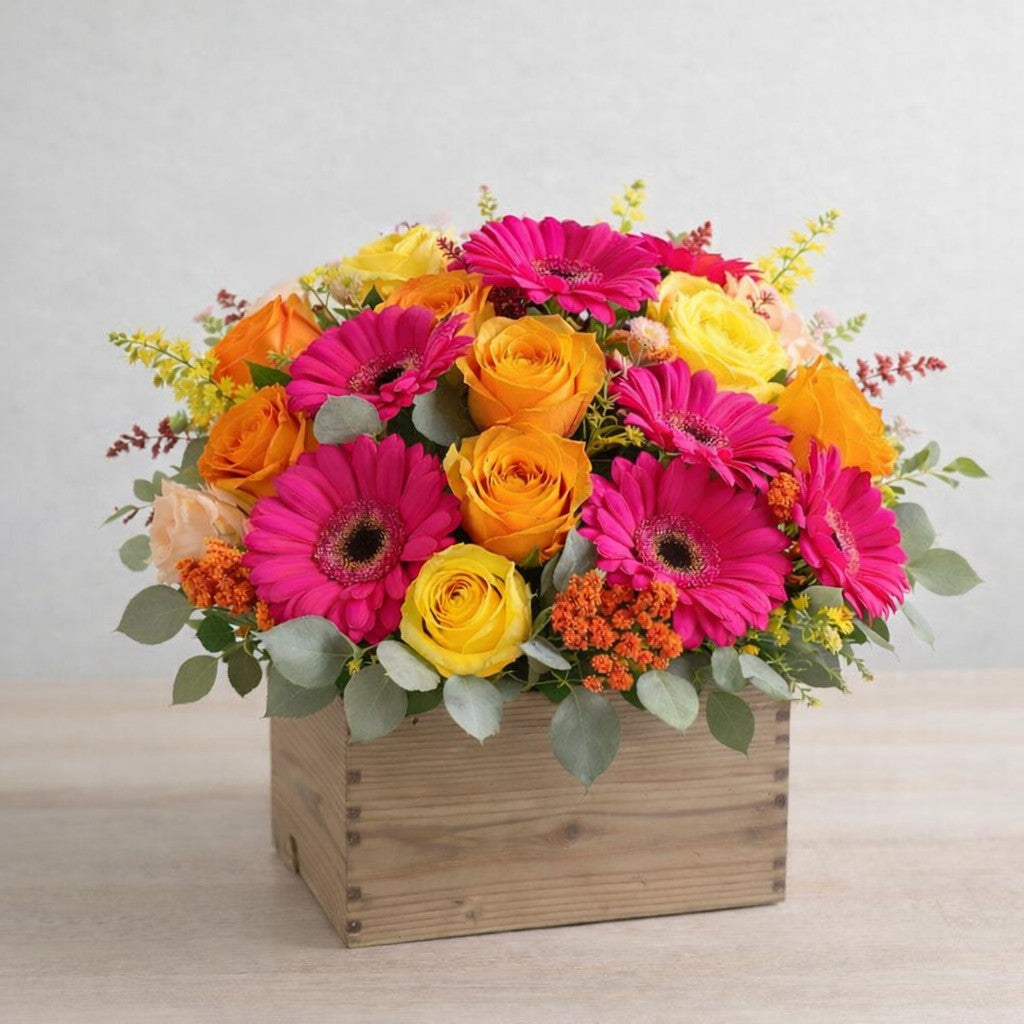 Gerbera and rose box arrangement with bright colorful flowers